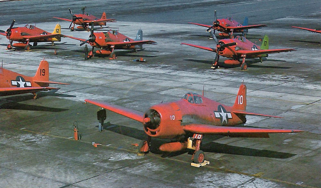 Remotely piloted F6Fs on the flight line at Bikini in 1946. These aircraft were flown through the radioactive cloud of atomic bomb tests. The different colored tails denote the radio frequency used to control them. (US Navy)